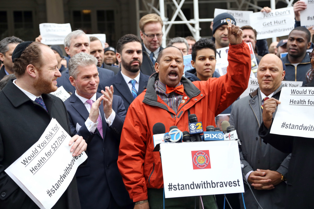 OFFICIALS RALLY BEHIND the UFA's campaign to raise disability benefits for new firefighters. At the podium is Councilman Andy King of the Bronx's 12th Council District. Photo courtesy Uniformed Firefighters Association