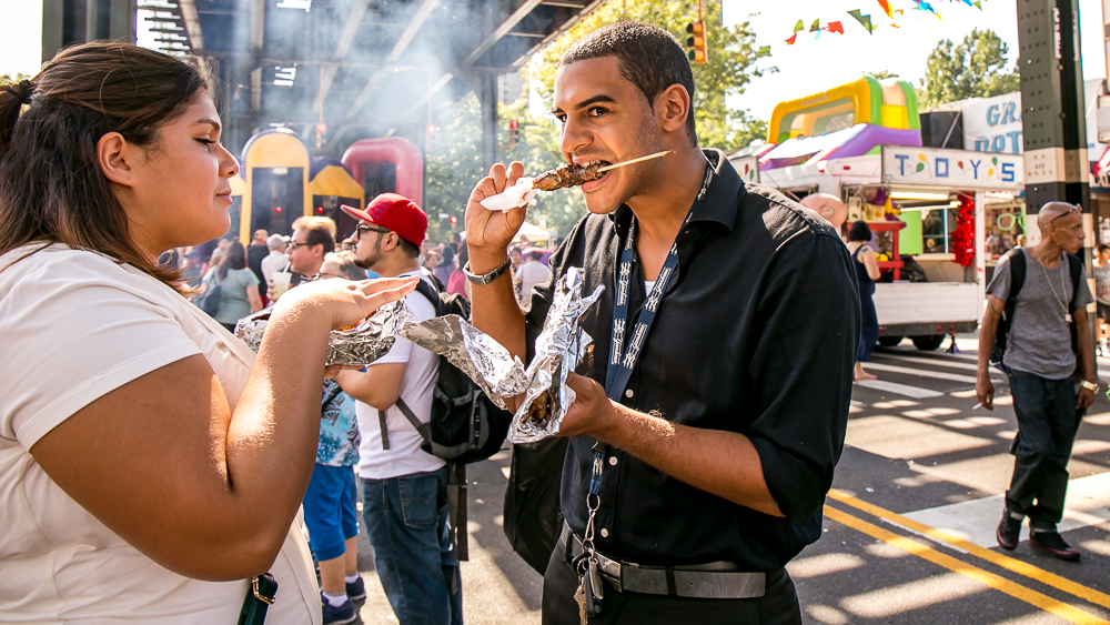 AN AFTERNOON SNACK. These two shoppers hang at the Fall Festival while munching on these meat on the stick delights. 