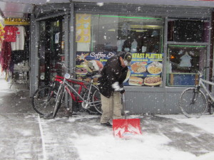 THIS WORKER SHOVELS outside New Star Coffee Shop.  Photo by David Cruz 