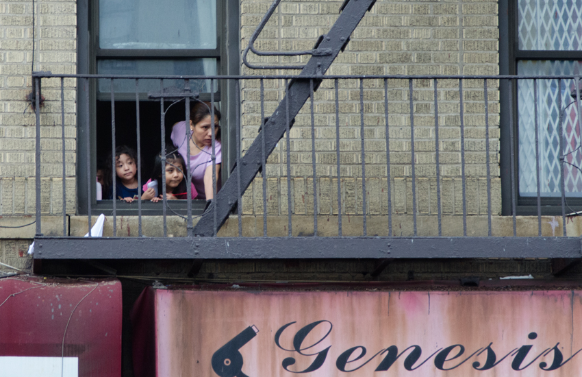 RESIDENTS OF LOCAL apartment buildings observed the procession. Photo by Jenny Sharp