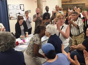 BRENDA CALDWELL, PRESIDENT of the 52nd Precinct Community Council congratulates Mary Vallati in reaching her 100th birthday and for being a longtime, active member of the Council. Photo by David Cruz 