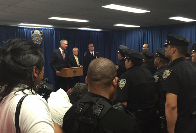 MAYOR BILL DE BLASIO (at podium) stands with NYPD Commissioner Bill Bratton and Chief of Department James O'Neill inside the 44th Precinct to announce the return of the "Summer All Out" program.  Photo by David Cruz 