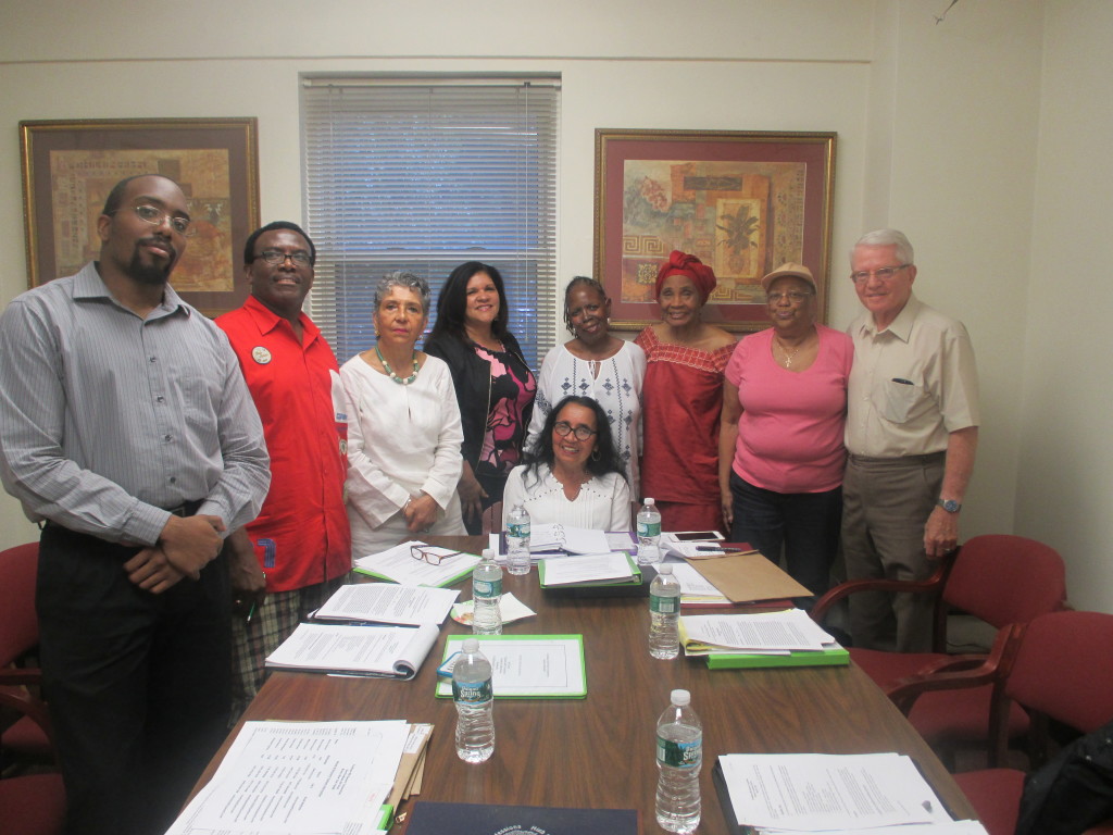  NEW BOARD MEMBERS at Fordham Hill Oval gather together before their meeting (l-r) Douglas Henry, Milton Francis, Dr. Pereta Rodriguez, Mryna Calderon, Sheila Hurdle, Elizabeth Tillman, Marlene Connor, and Israel Ruiz, Jr. Seated is the new board president, Dr. Nancy Alvarez.  Photo by Tatyana Turner