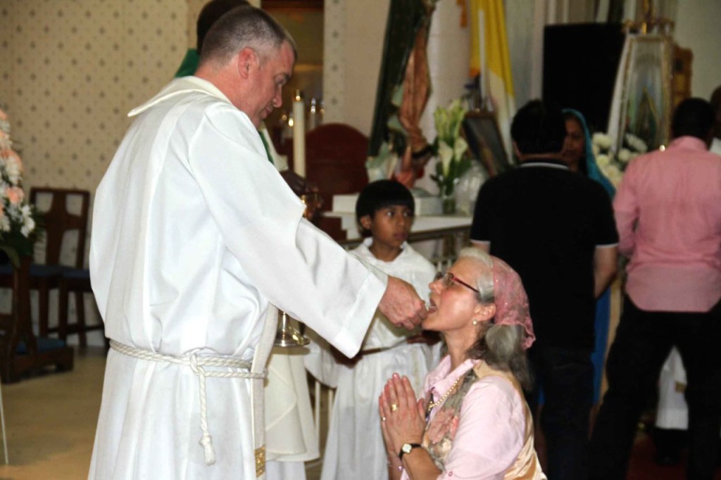 FR. GEORGE STEWART, former St. Brendan's pastor, helps lead services at St. Ann's in a sign of solidarity. St. Ann's is expected to merge with St. Brendan's Church on East 206th Street.  Photo by David Greene 