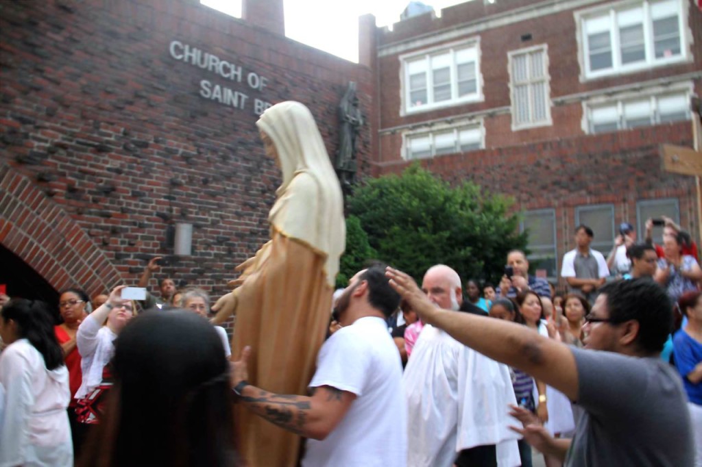 PARISHIONERS CARRY THE statue of St. Ann's during a procession through Norwood.  Photo by David Greene