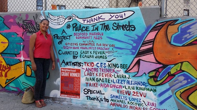 SAMELYS LOPEZ STANDS alongside the newly painted mural at the corner of Briggs Avenue and 202nd Street. Funding was made possible from a grant by the Citizens Committee for New York City. Photo courtesy Facebook