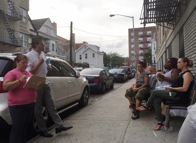 TENANTS AT 319 E. 197th ST. hold an emergency meeting over speculation a cluster-site shelter would operate inside their building. They sit on brand new chairs reserved for empty apartments. Photo by David Cruz 