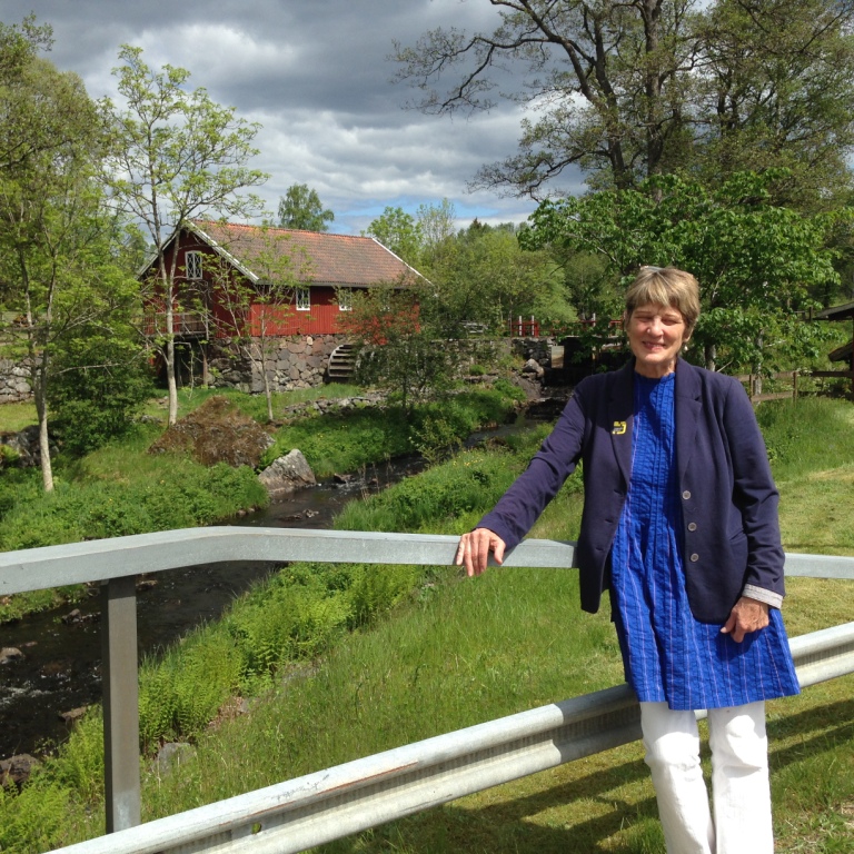 JANET NORQUIST-GONZALEZ of Norwood stands in front of a Sävsjö mill site during a trip to Sweden, birthplace of borough founder Jonas Bronck, over the summer. Photo courtesy Janet Norquist-Gonzalez 