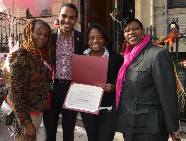 NICOLE WATSON (second from left) picks up a citation for helping to pull the Halloween event together. She shares a moment with (l-r) her sister Shanequa Charles, Councilman Ritchie Torres and Bronx District Attorney-elect Darcel Clark.  Photo by Miriam Quinones