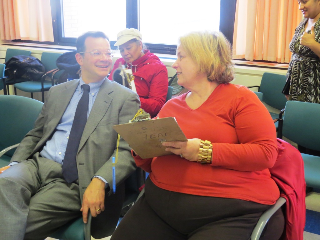 COUNCILMAN ANDREW COHEN, sitting with Community Board 7 member Lowell Green, urges Bronxites to apply for a free IDNYC card. Photo by Jasmine Gomez 