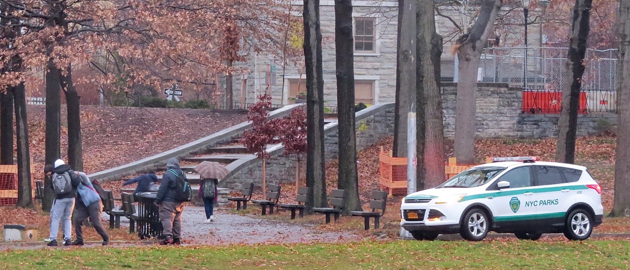 A PARKS ENFORCEMENT PATROL vehicle stops in front of this fight between underage boys at Williamsbridge Oval Park, a common problem at the park. Photo by David Cruz 