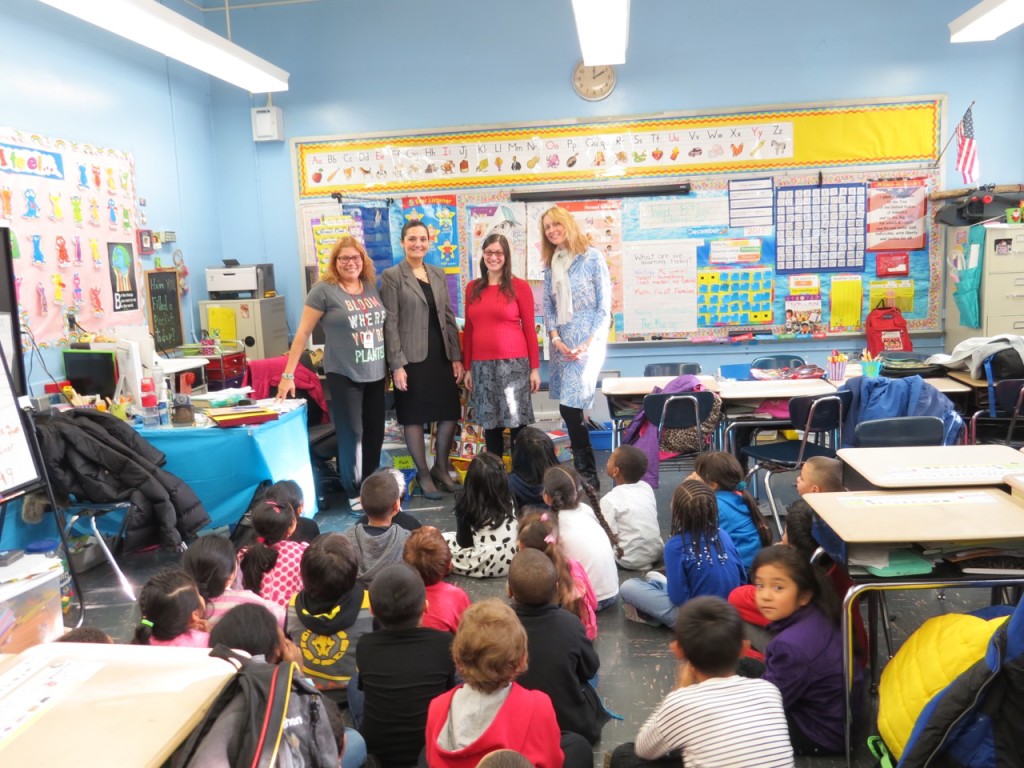 MUSIC LIVES AT PS 8. (l-r) PS 8 principal Claudia Tahiraj, Education through Music teacher, Emily Feinberg-Hofier, and full-time music teacher for PS 8, Shoshana Kaye, pose with a class of PS 8 students. Photo by Adedamola Agboola 